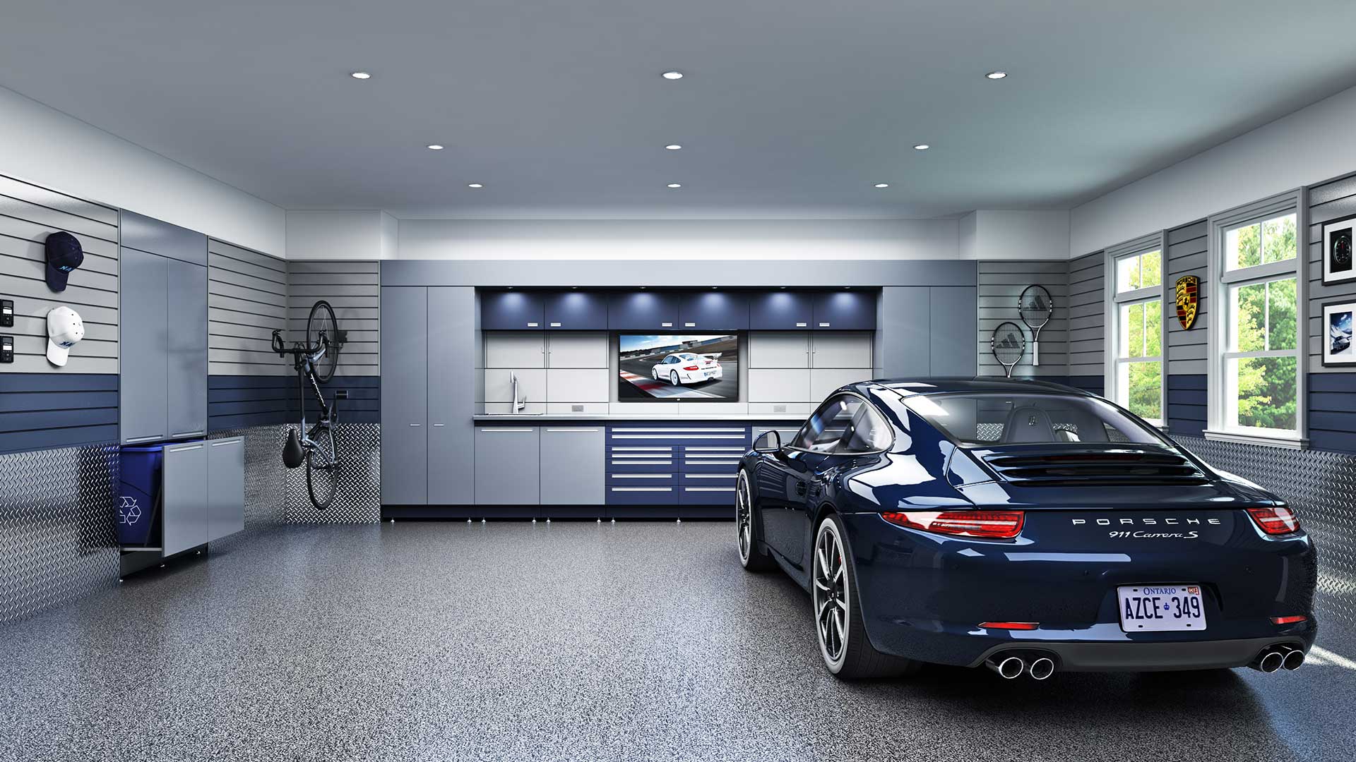 Luxury garage with Armor-Kote epoxy flake floor, custom cabinets and a sports car